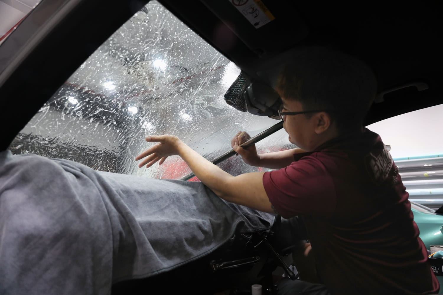 Solar Film Tinting Application on Car Window Professional solar film tinting being applied to car window for heat and UV protection.
